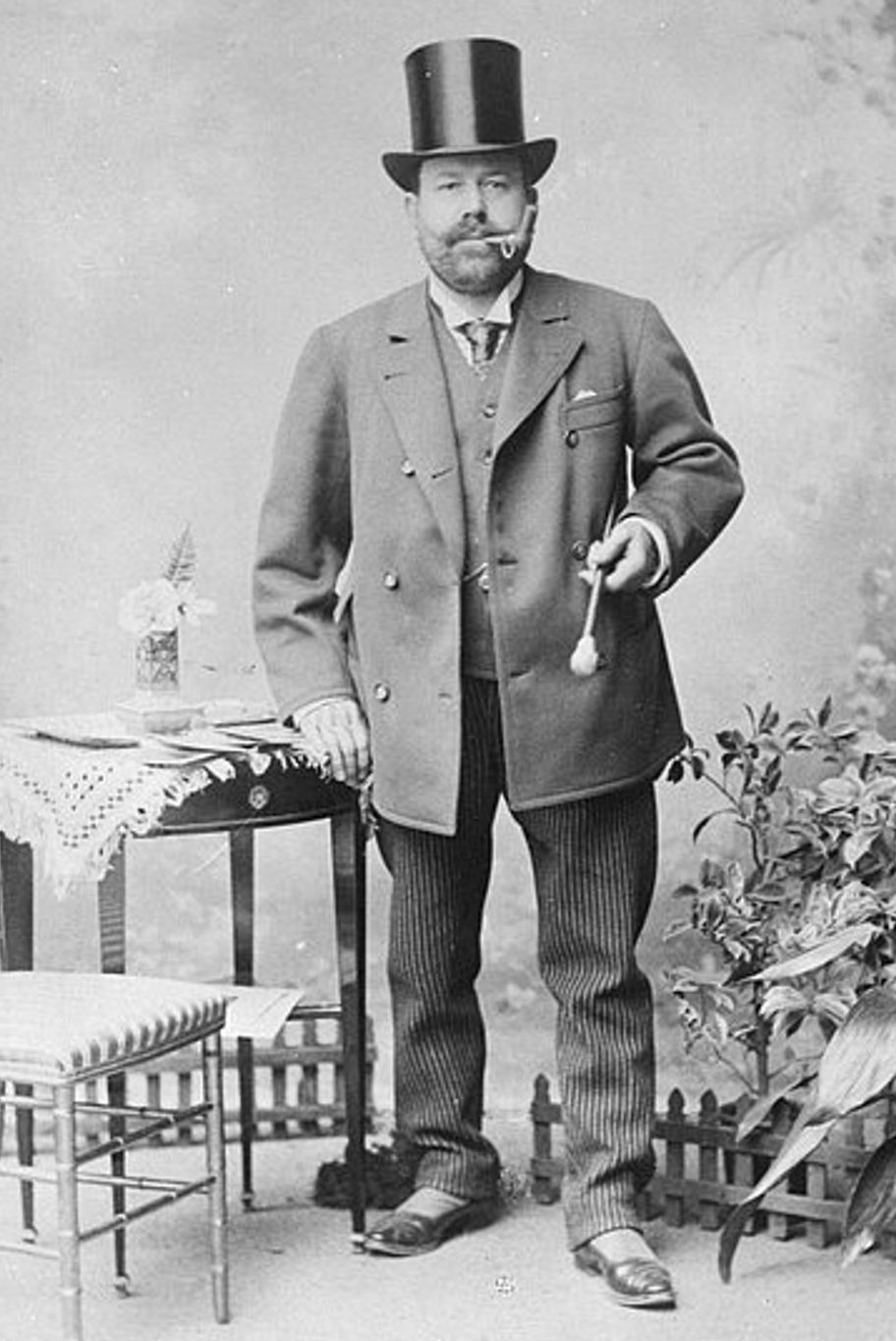 Viennese cab driver Josef Bratfisch poses in a formal photograph wearing the customary outfit of his profession, complete with a top hat and pin-stripe pants